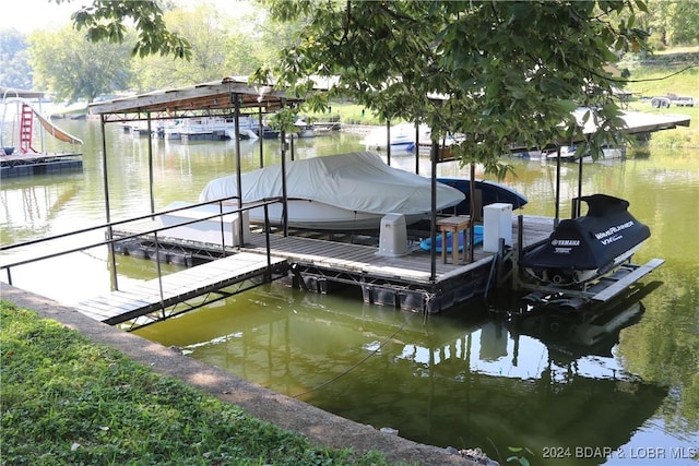 dock area with a water view and boat lift