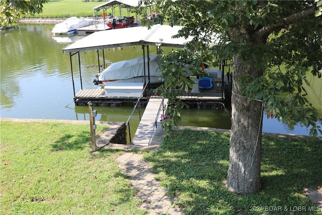 view of dock featuring a yard and a water view