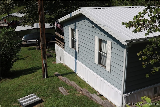 view of side of home with a lawn