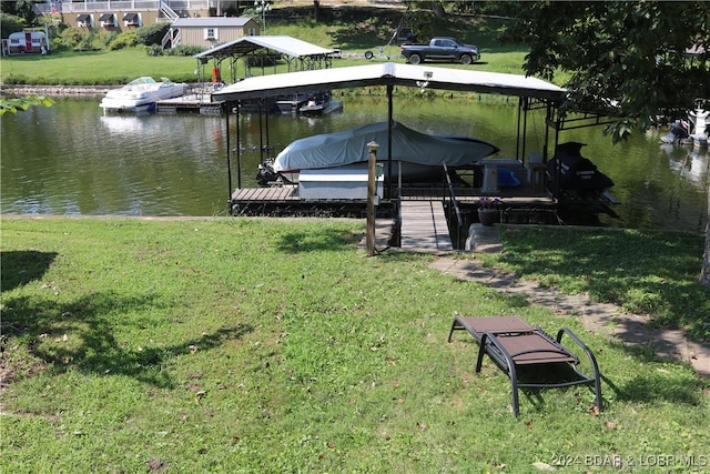 view of dock with a water view and a yard