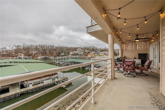 balcony with a water view and a boat dock