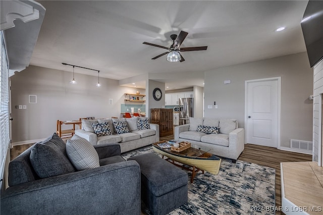 living room featuring hardwood / wood-style floors, ceiling fan, and track lighting