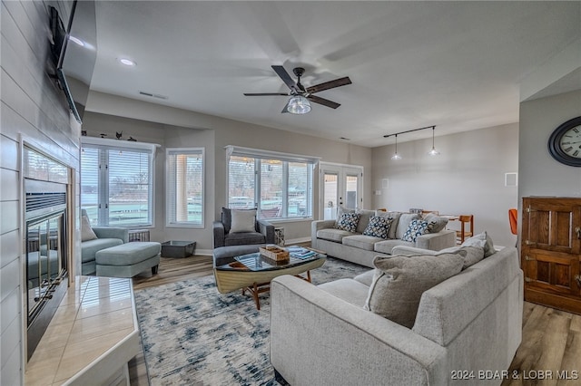 living room featuring light wood-type flooring and ceiling fan