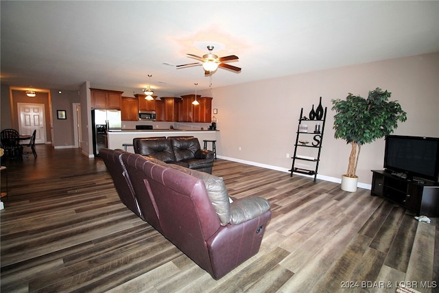 living room with ceiling fan and hardwood / wood-style floors