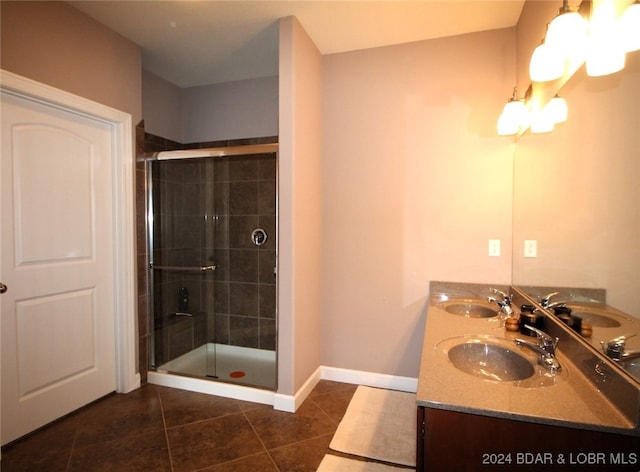 bathroom featuring tile patterned flooring, vanity, and walk in shower