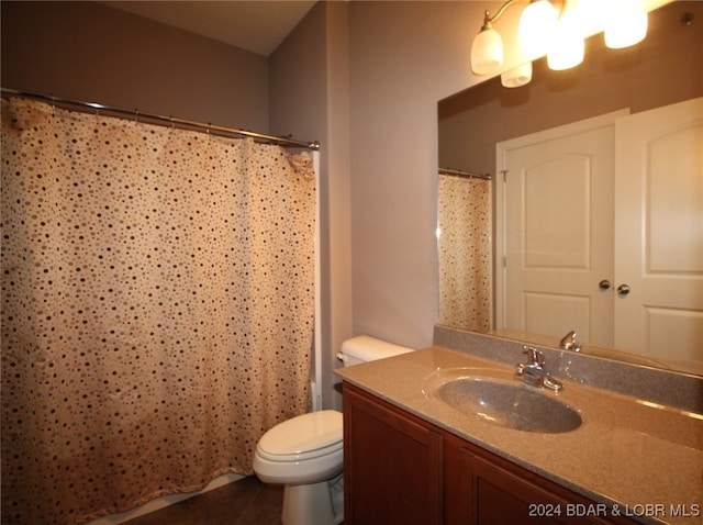 bathroom featuring vanity, toilet, a shower with curtain, and tile patterned floors