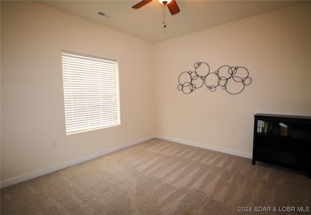 unfurnished room with ceiling fan and carpet floors