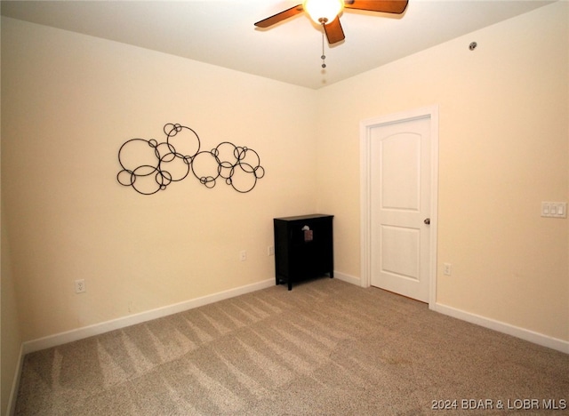 spare room featuring ceiling fan and carpet