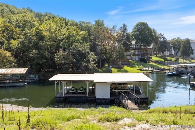 dock area with a water view and boat lift