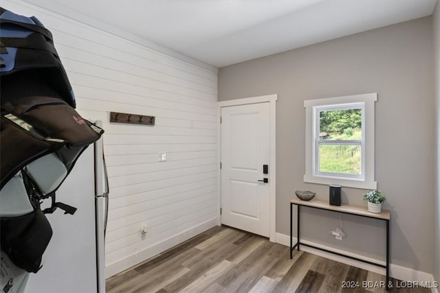 interior space with wood-type flooring and wooden walls