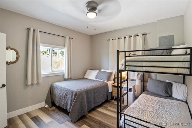 bedroom featuring ceiling fan, baseboards, and wood finished floors