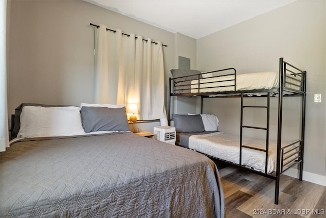 bedroom featuring wood finished floors and baseboards