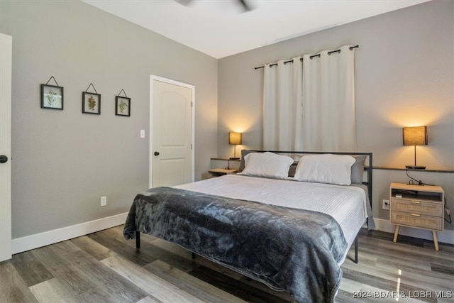 bedroom with hardwood / wood-style floors and ceiling fan