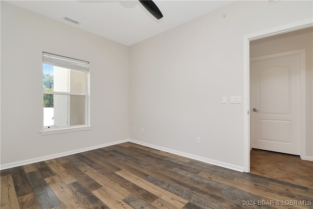 empty room with dark wood-type flooring and ceiling fan