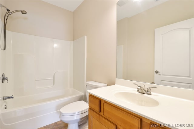 full bathroom featuring washtub / shower combination, tile patterned flooring, toilet, and vanity