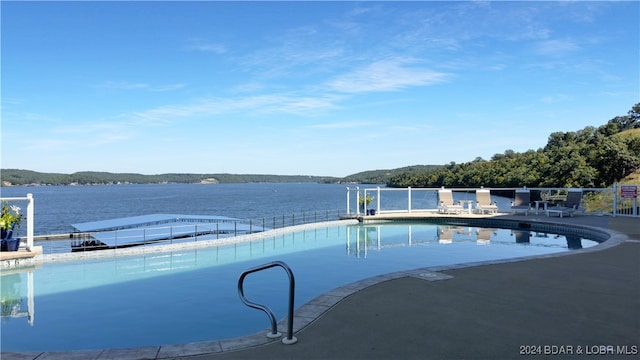 view of swimming pool featuring a water view