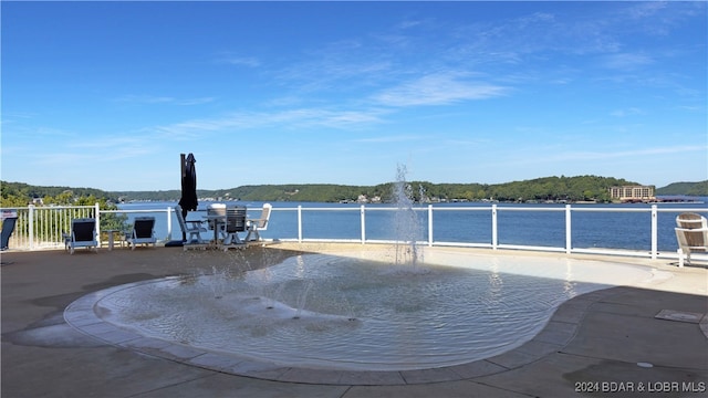 view of pool with a water view