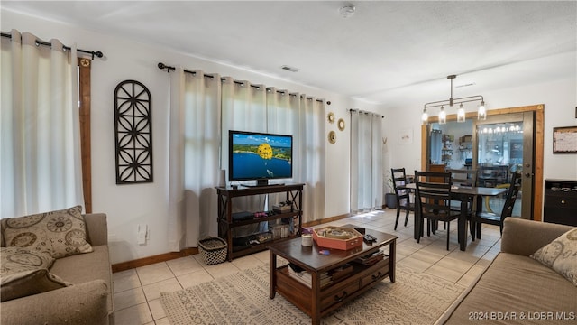 living room featuring a chandelier and light tile patterned flooring