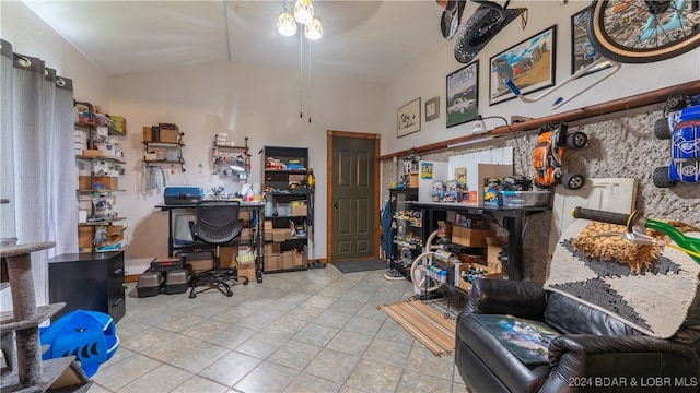 office with vaulted ceiling, light tile patterned floors, and ceiling fan