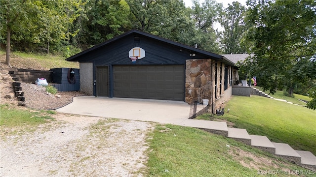 exterior space featuring a garage and a front yard