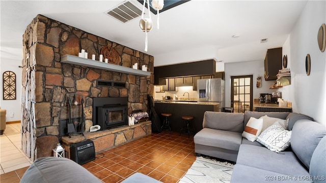 tiled living room with sink and a fireplace