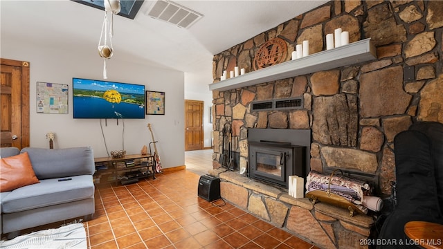 living room with tile patterned flooring, lofted ceiling, and a fireplace