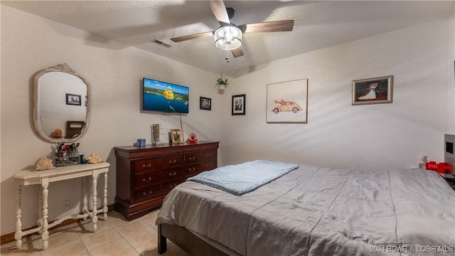 tiled bedroom featuring ceiling fan