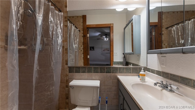 bathroom featuring toilet, vanity, decorative backsplash, tile walls, and a shower with shower curtain