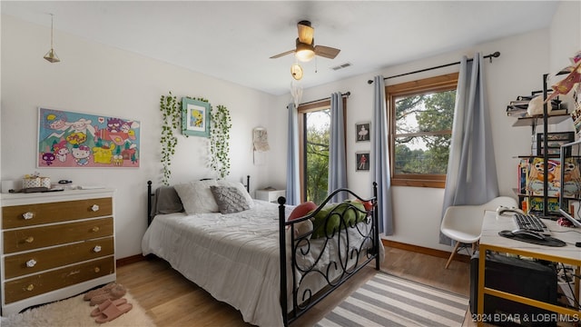 bedroom with light hardwood / wood-style flooring and ceiling fan