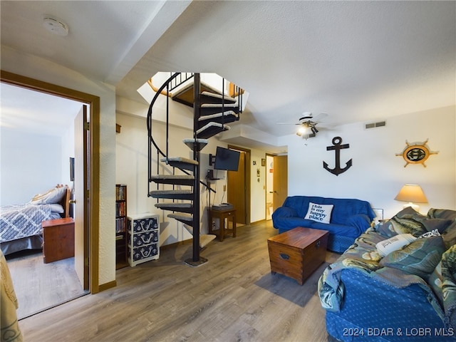 living room with ceiling fan and hardwood / wood-style floors