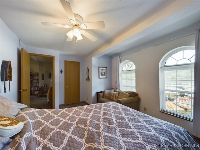 bedroom featuring a textured ceiling and ceiling fan