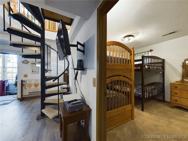 interior space featuring hardwood / wood-style floors and a textured ceiling