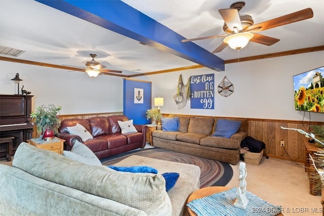 carpeted living room featuring ornamental molding, wooden walls, and ceiling fan