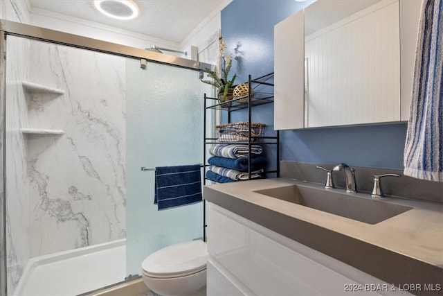 bathroom with a textured ceiling, walk in shower, toilet, vanity, and crown molding