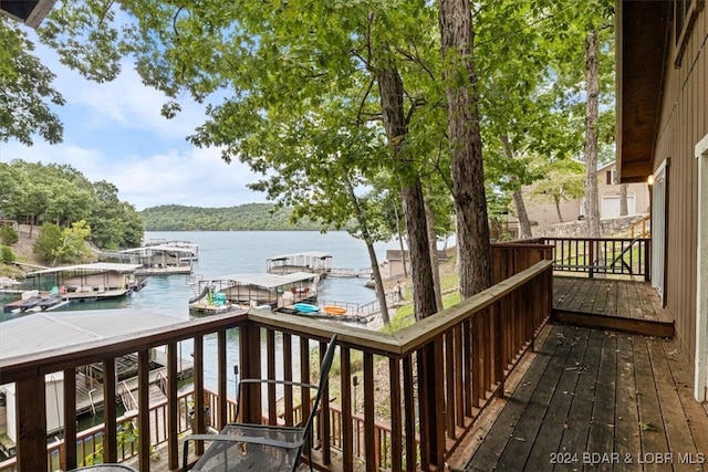 wooden terrace with a water view and a boat dock