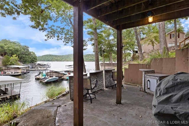 view of patio featuring a dock and a water view