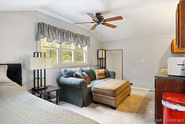 living room featuring vaulted ceiling, light colored carpet, and ceiling fan