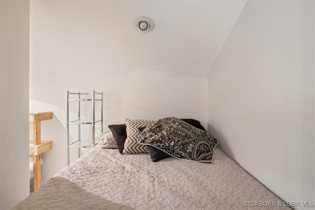 bedroom with vaulted ceiling and carpet floors