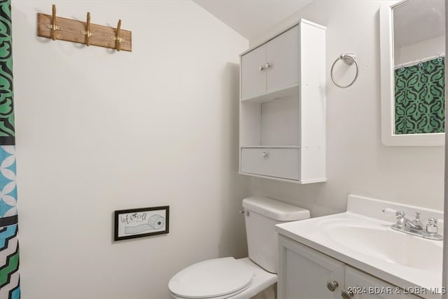 bathroom featuring vanity and toilet