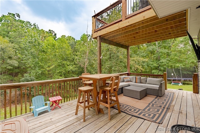 deck featuring an outdoor hangout area and a trampoline