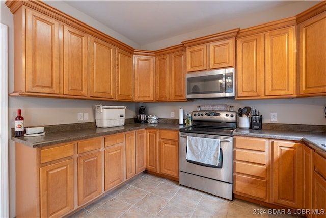 kitchen featuring light tile patterned flooring and stainless steel appliances