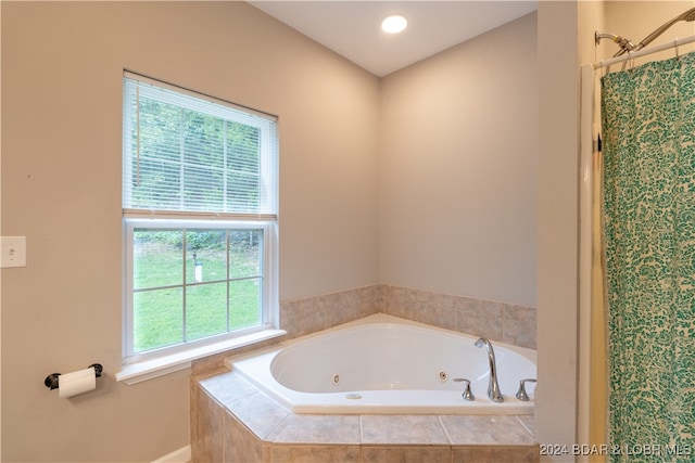 bathroom featuring shower with separate bathtub