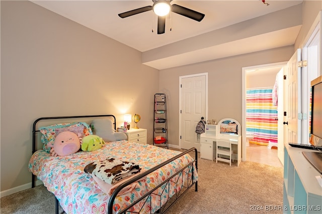 bedroom featuring ceiling fan and light colored carpet