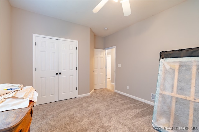 interior space with ceiling fan and a closet