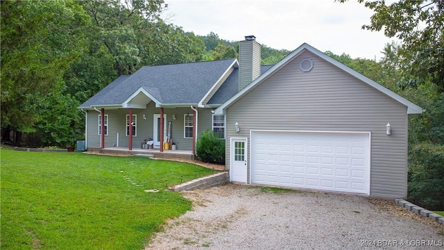 view of front of house with a garage, a front lawn, and a porch