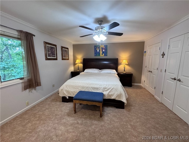 carpeted bedroom with ceiling fan and ornamental molding