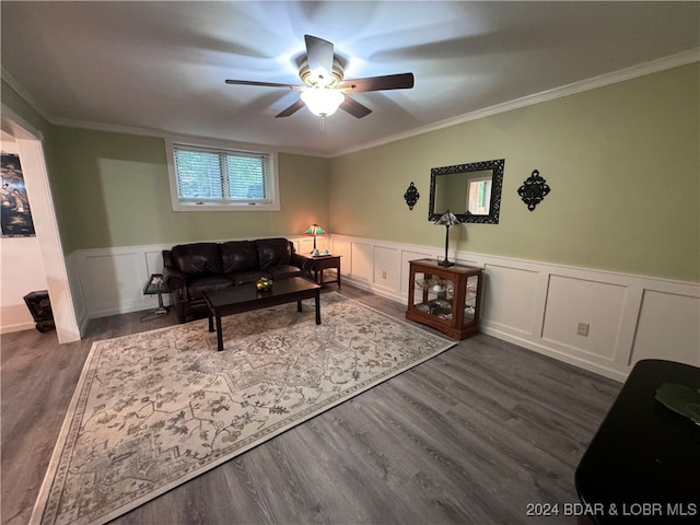 living room featuring crown molding, ceiling fan, and dark wood-type flooring