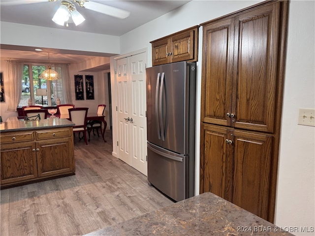 kitchen with pendant lighting, light hardwood / wood-style floors, stainless steel fridge, and ceiling fan