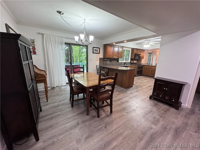 dining space with ceiling fan with notable chandelier, light hardwood / wood-style flooring, and ornamental molding