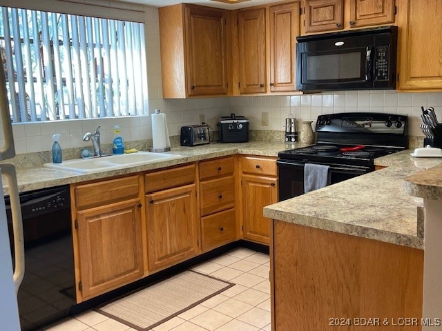 kitchen with backsplash, black appliances, light tile patterned flooring, and sink